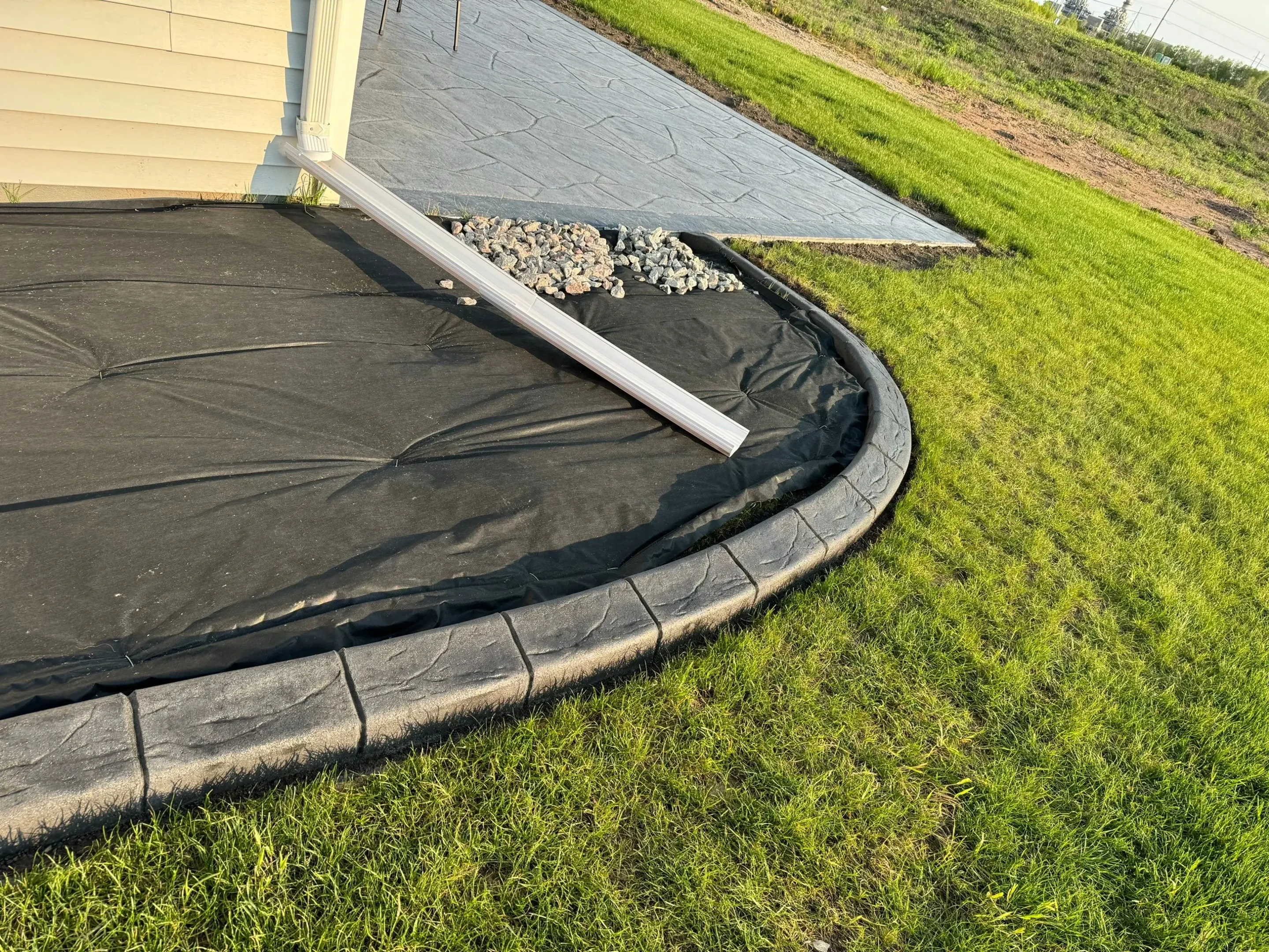 Decorative stamped concrete curbing with brick pattern